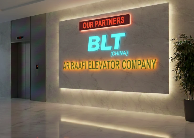An office lobby featuring a marble wall with the "BLT (CHINA)" logo and "AR RAAFI ELEVATOR COMPANY" in lettering under an "OUR PARTNERS" sign.